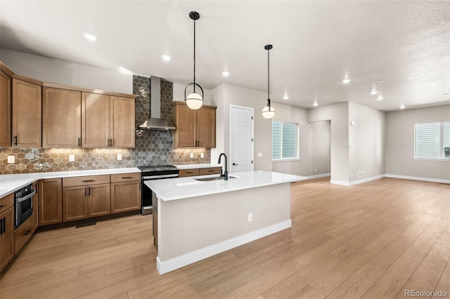 16605 Peak St, Broomfield, CO 80023 - kitchen featuring wall chimney exhaust hood, stainless steel appliances, light wood-type flooring, backsplash, and recessed lighting