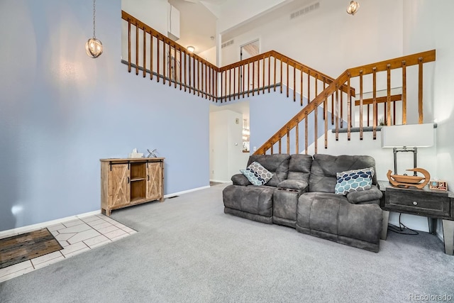 living room with carpet flooring and a towering ceiling