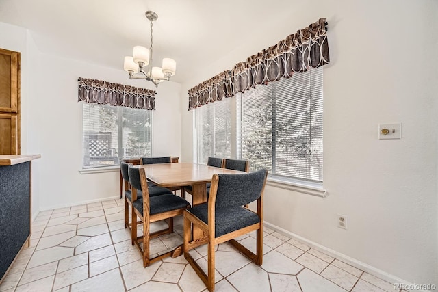 dining space featuring light tile patterned floors and a chandelier