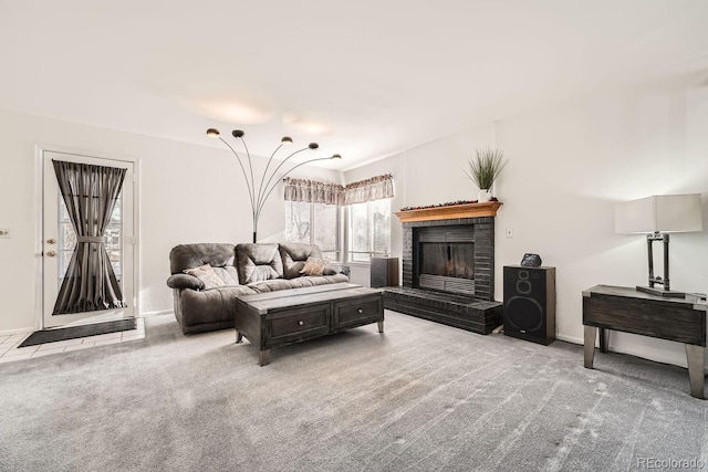 living room with light carpet and a brick fireplace