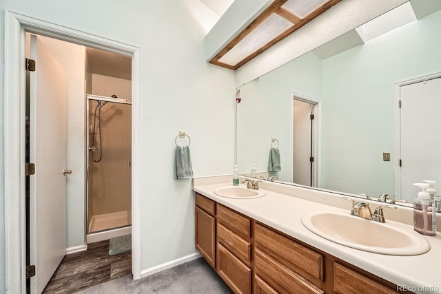 bathroom featuring vanity and a shower with door