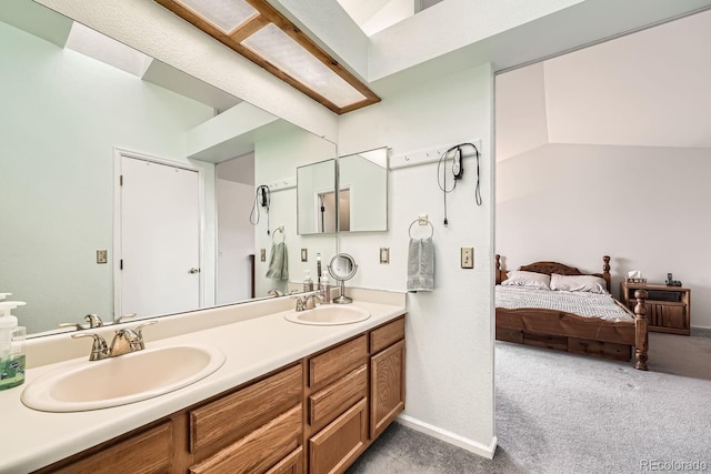 bathroom with vanity and lofted ceiling