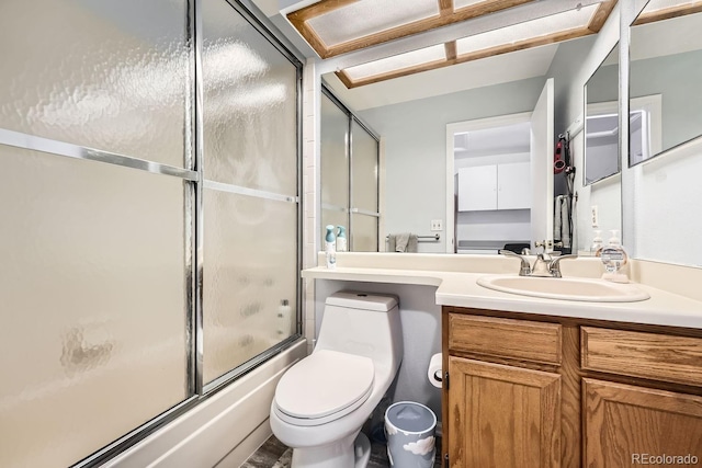 full bathroom featuring vanity, toilet, and bath / shower combo with glass door