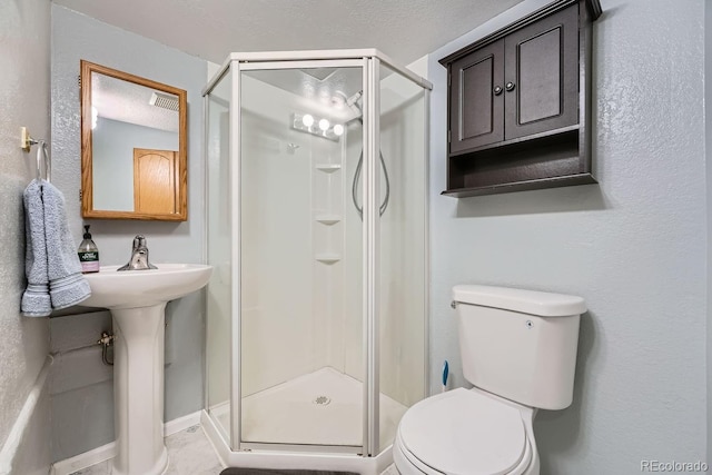 bathroom with a shower with door and toilet