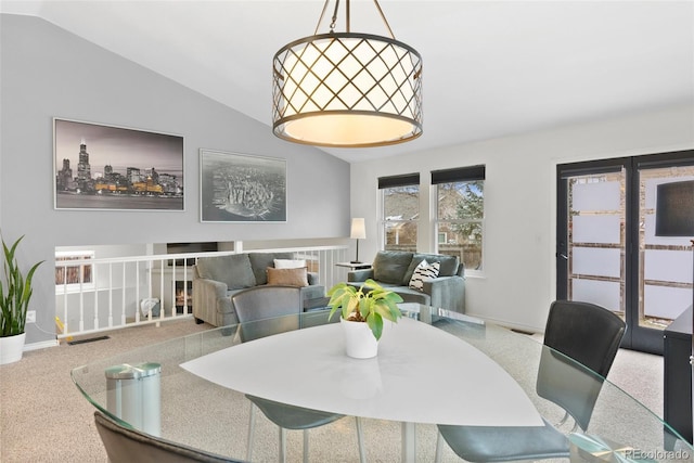 dining area with carpet and lofted ceiling