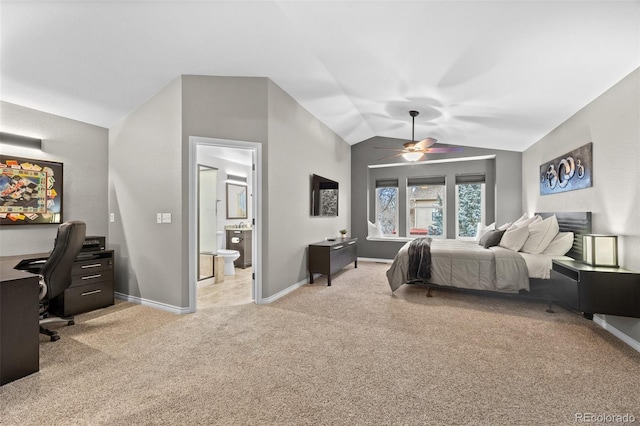 carpeted bedroom with ensuite bathroom, vaulted ceiling, and ceiling fan