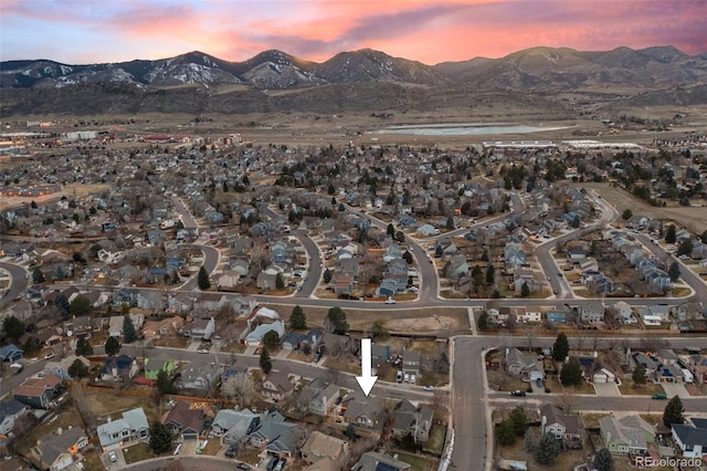 aerial view at dusk featuring a mountain view