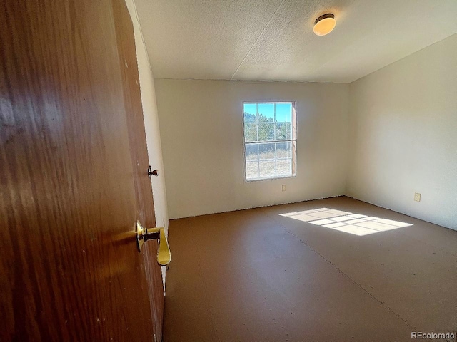 spare room with a textured ceiling