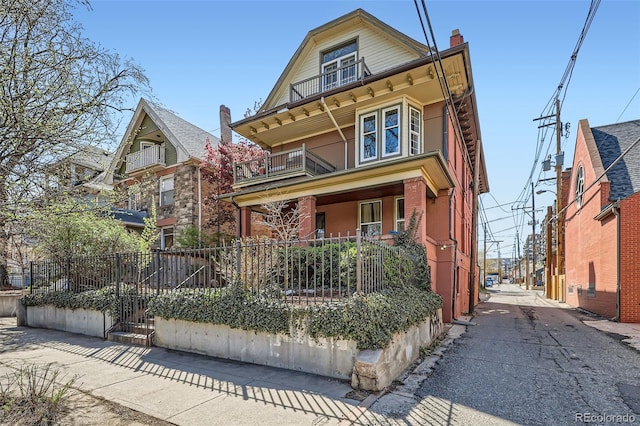 2122 E 13th Ave, Denver, CO 80206 - view of front facade featuring a porch, a chimney, and a balcony