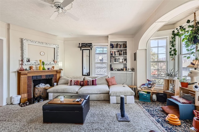 2122 E 13th Ave, Denver, CO 80206 - living area with a ceiling fan, a brick fireplace, and a textured ceiling