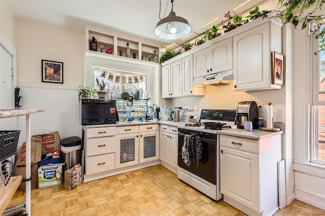 2122 E 13th Ave, Denver, CO 80206 - kitchen featuring white cabinets, light countertops, white range with gas cooktop, and under cabinet range hood