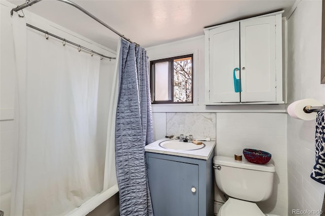2122 E 13th Ave, Denver, CO 80206 - full bath with shower / tub combo with curtain, toilet, vanity, and tile walls