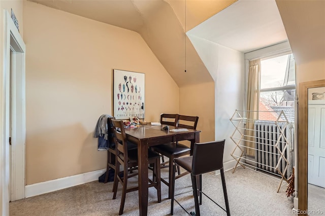 2122 E 13th Ave, Denver, CO 80206 - carpeted dining space with vaulted ceiling and baseboards