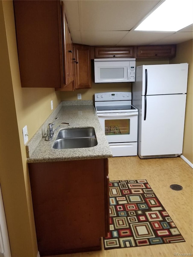 2122 E 13th Ave, Denver, CO 80206 - kitchen with light countertops, a paneled ceiling, a sink, and white appliances