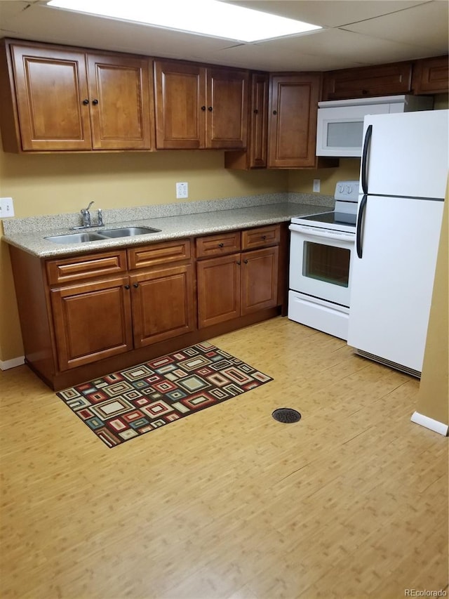 2122 E 13th Ave, Denver, CO 80206 - kitchen featuring light countertops, white appliances, a sink, and brown cabinets