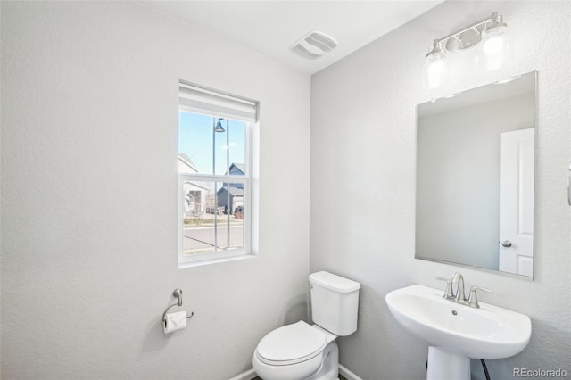 bathroom featuring toilet and sink