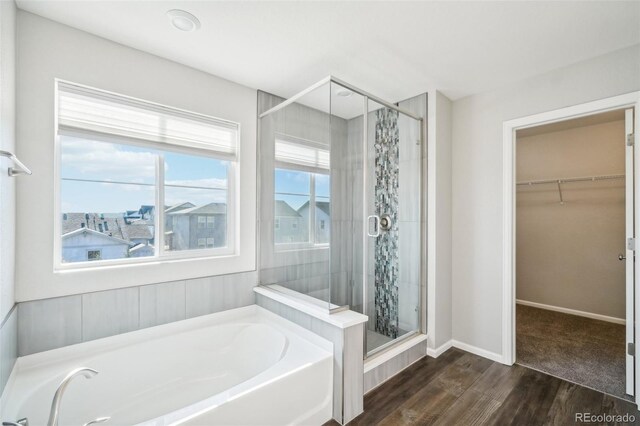 bathroom with plus walk in shower and hardwood / wood-style flooring