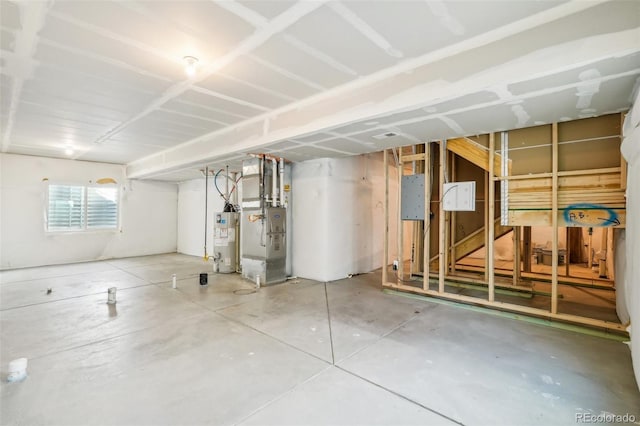 basement featuring gas water heater and heating unit