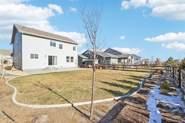 back of property with a patio and a lawn