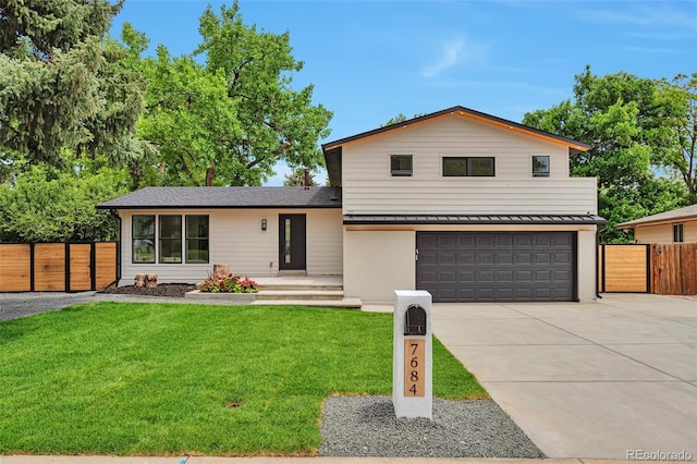 7684 S Ingalls St, Littleton, CO 80128 - split level home with an attached garage, driveway, a standing seam roof, and a metal roof