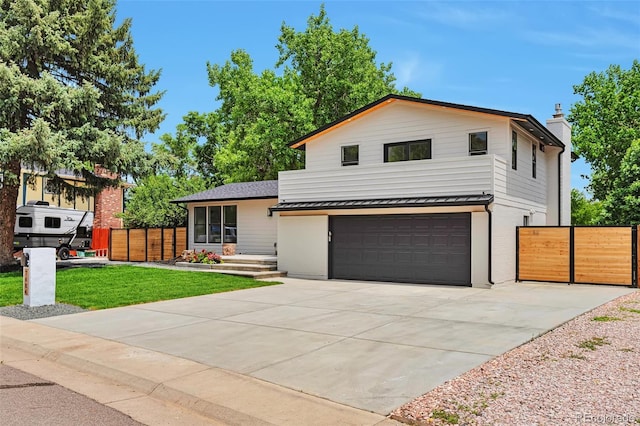 7684 S Ingalls St, Littleton, CO 80128 - view of front of home featuring an attached garage, driveway, and a chimney