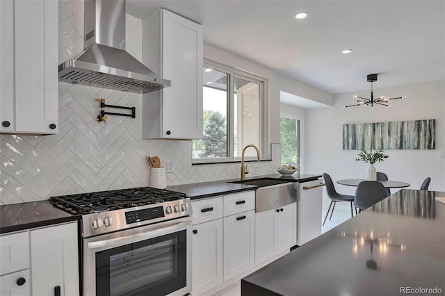 7684 S Ingalls St, Littleton, CO 80128 - kitchen with gas range, wall chimney exhaust hood, dark countertops, white dishwasher, and recessed lighting