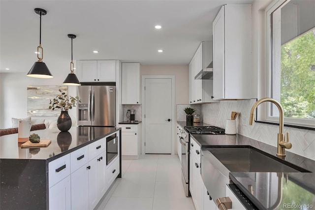 7684 S Ingalls St, Littleton, CO 80128 - kitchen featuring appliances with stainless steel finishes, plenty of natural light, backsplash, recessed lighting, and white cabinetry