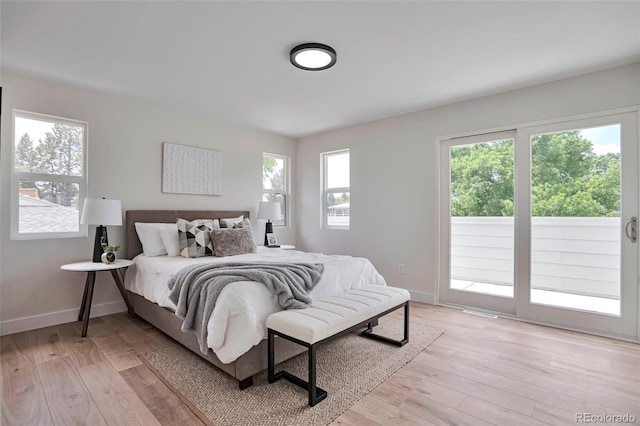 7684 S Ingalls St, Littleton, CO 80128 - bedroom featuring access to exterior and light wood-style floors