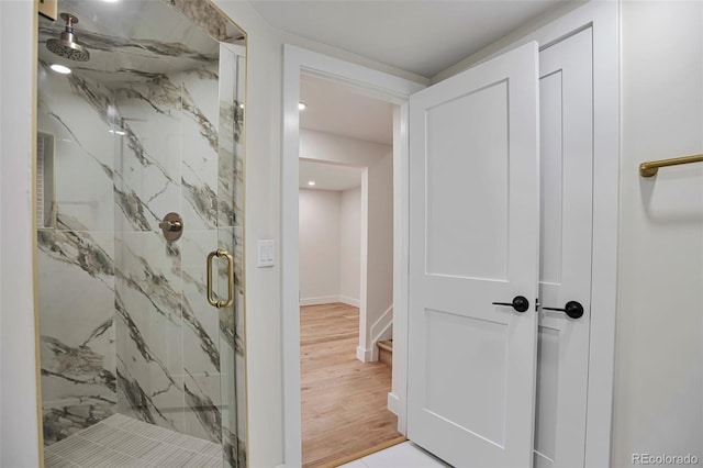 7684 S Ingalls St, Littleton, CO 80128 - full bathroom featuring a marble finish shower and wood finished floors