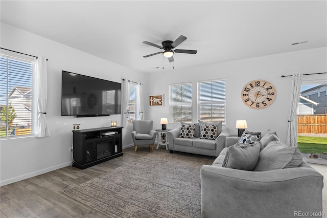 living room with light hardwood / wood-style floors and a healthy amount of sunlight