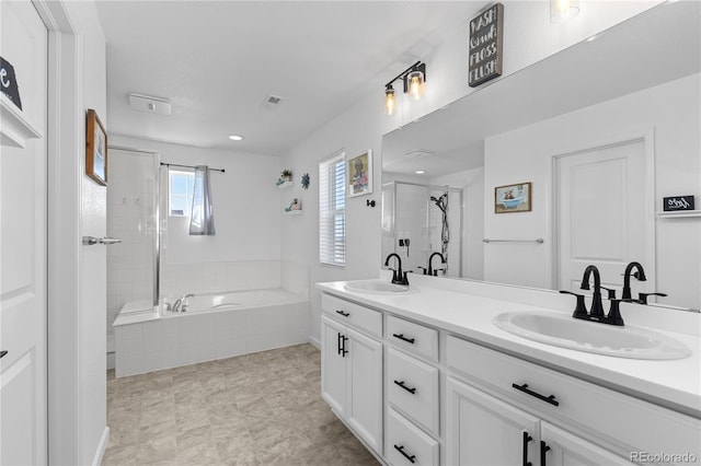 bathroom with vanity and independent shower and bath