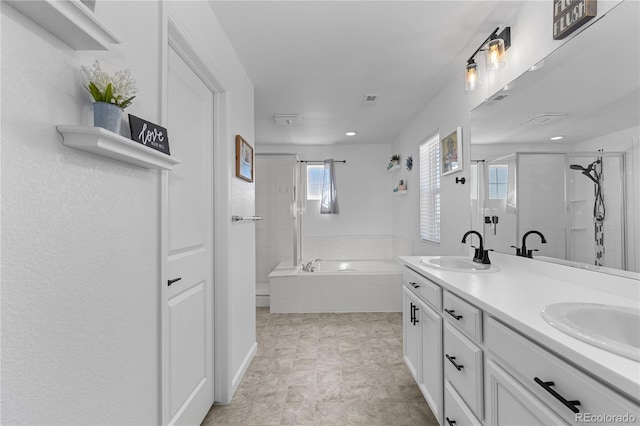 bathroom with vanity and independent shower and bath