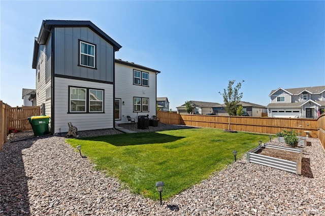 rear view of property featuring a yard