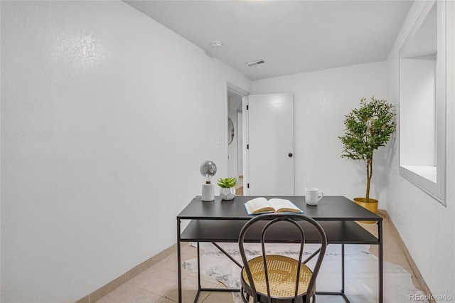 office area with visible vents, baseboards, and light tile patterned floors