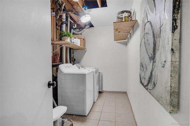 laundry room with tile patterned flooring, laundry area, and washing machine and clothes dryer