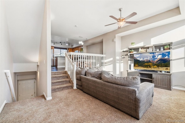 living room featuring rail lighting, light colored carpet, and ceiling fan