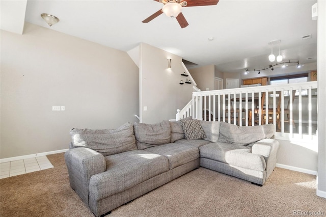 living room with rail lighting, ceiling fan, and carpet flooring