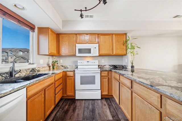 kitchen featuring dark hardwood / wood-style flooring, sink, light stone counters, and white appliances