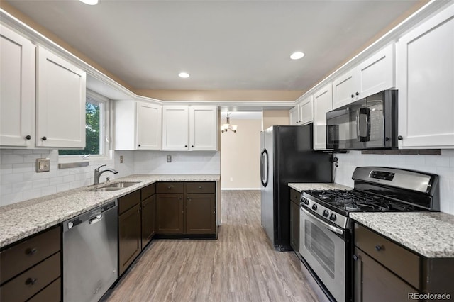 kitchen with sink, light hardwood / wood-style flooring, dark brown cabinets, white cabinetry, and stainless steel appliances