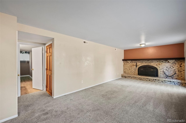 unfurnished living room with carpet and a wood stove