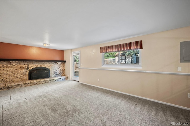 unfurnished living room with electric panel, carpet floors, and a brick fireplace