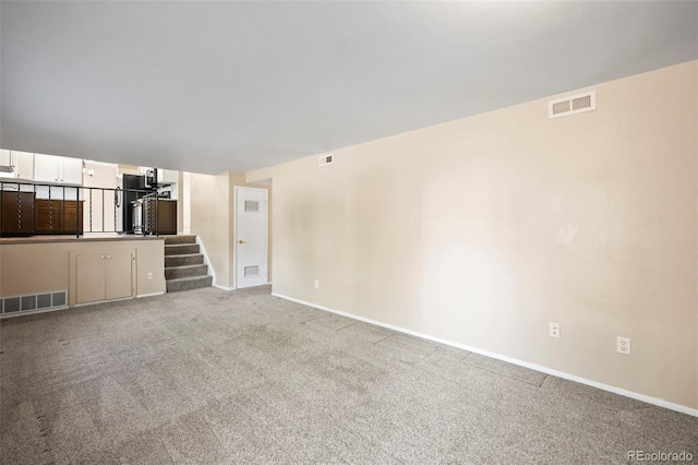 unfurnished living room featuring light colored carpet