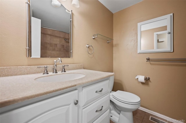 bathroom with a shower, tile patterned flooring, vanity, and toilet