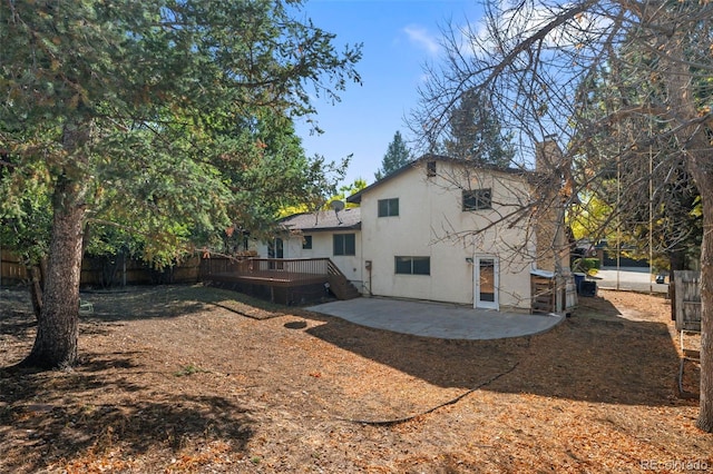 rear view of house with a deck and a patio area