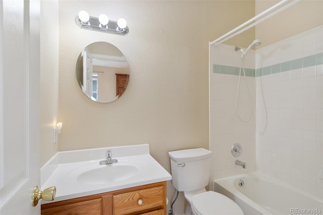 full bathroom with tiled shower / bath, vanity, and toilet