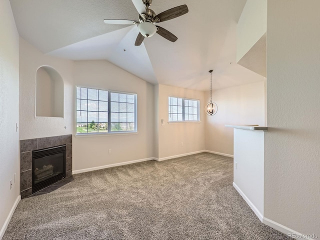 5705 N Genoa Way Unit 308, Aurora, CO 80019 - unfurnished living room with a fireplace, carpet floors, vaulted ceiling, a ceiling fan, and baseboards
