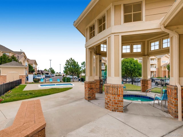 5705 N Genoa Way Unit 308, Aurora, CO 80019 - view of patio / terrace featuring a hot tub and a community pool