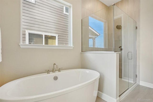 5930 S Platte Canyon Dr, Littleton, CO 80123 - full bathroom featuring a shower stall, a freestanding bath, and baseboards