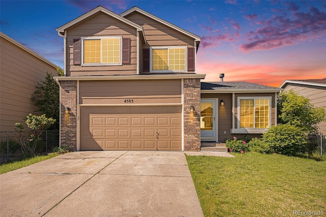 4585 Jet Wing Cir, Colorado Springs, CO 80916 - traditional-style house featuring a garage, driveway, and brick siding