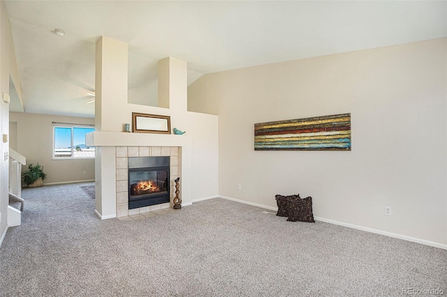 4585 Jet Wing Cir, Colorado Springs, CO 80916 - unfurnished living room with carpet flooring, a tiled fireplace, baseboards, and vaulted ceiling